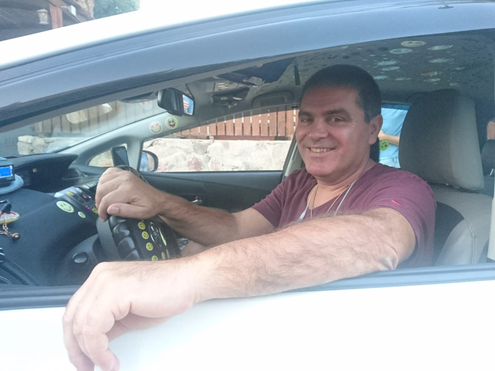 נהג ממוניות שדה התעופה רמון מחייך ברכב